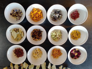Dried flower petals in small bowls before mixed